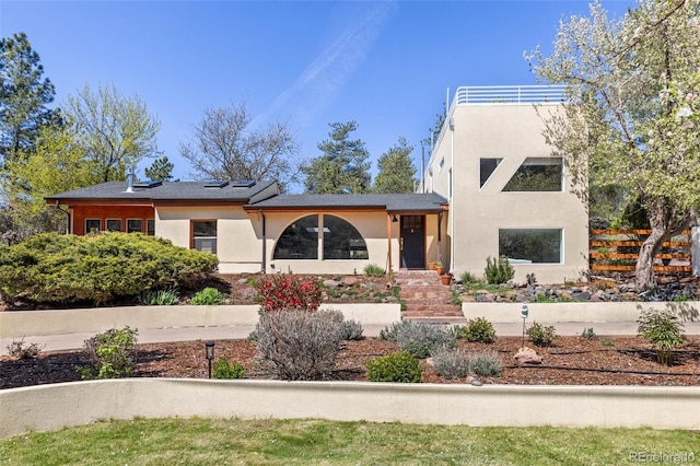 1669 Apple Valley Rd, Lyons, CO 80540 - view of front facade with stucco siding and solar panels