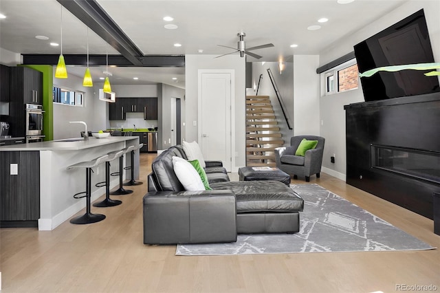 3453 Navajo St, Denver, CO 80211 - living room with light wood-type flooring, stairway, recessed lighting, ceiling fan, and baseboards