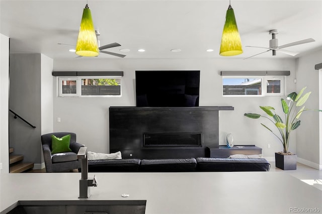 3453 Navajo St, Denver, CO 80211 - living area featuring a ceiling fan, stairway, a glass covered fireplace, plenty of natural light, and recessed lighting
