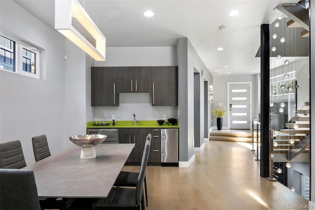 3453 Navajo St, Denver, CO 80211 - kitchen featuring light wood-style flooring, dark brown cabinetry, a sink, light countertops, and modern cabinets