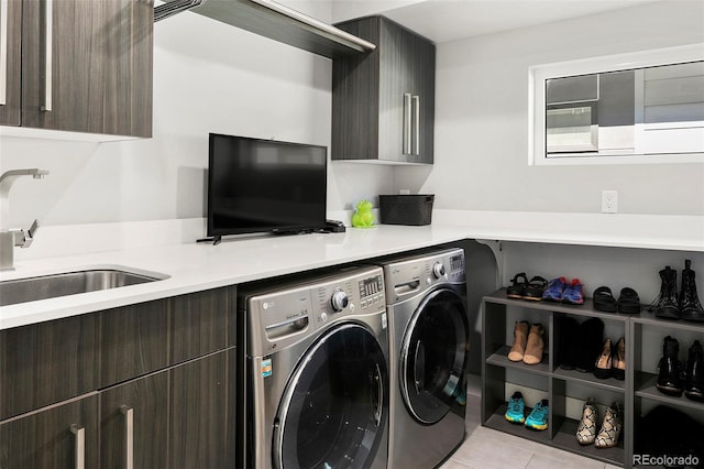 3453 Navajo St, Denver, CO 80211 - laundry area with washing machine and clothes dryer, cabinet space, and light tile patterned floors