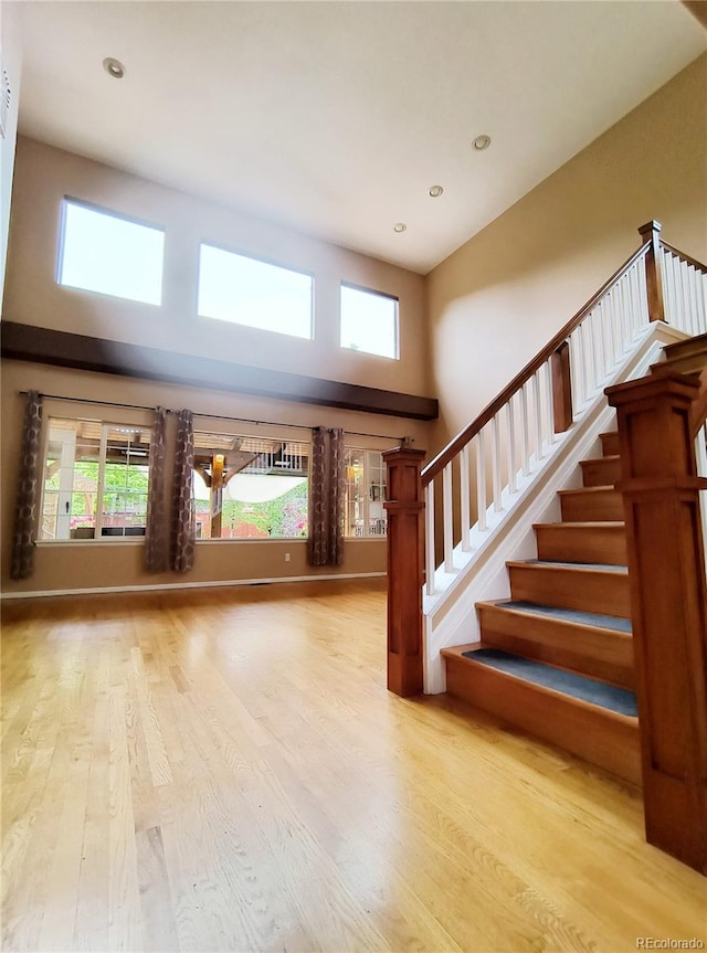 10154 Fairgate Way, Highlands Ranch, CO 80126 - foyer featuring a towering ceiling, stairway, wood finished floors, healthy amount of natural light, and recessed lighting
