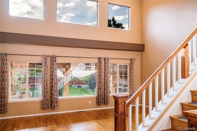 10154 Fairgate Way, Highlands Ranch, CO 80126 - foyer entrance with wood finished floors, a high ceiling, and stairway
