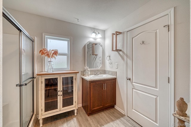 310 Chipeta Ave, Poncha Springs, CO 81242 - full bath featuring wood finished floors, a stall shower, and vanity