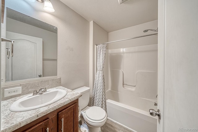 310 Chipeta Ave, Poncha Springs, CO 81242 - bathroom with toilet, vanity, shower / bath combo with shower curtain, a textured wall, and a textured ceiling