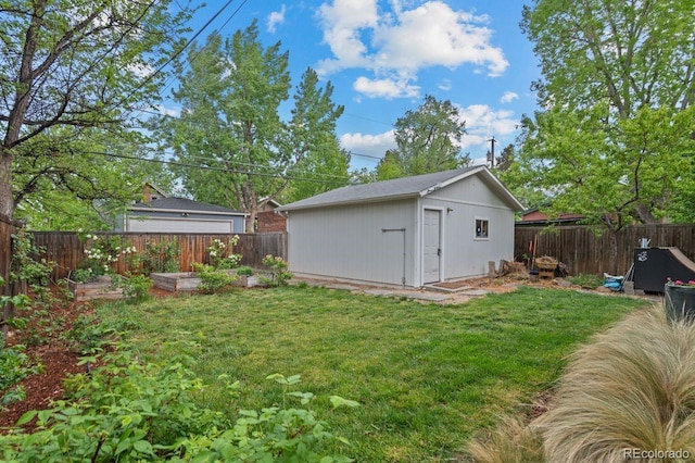 view of yard featuring an outbuilding, a garden, and a storage unit