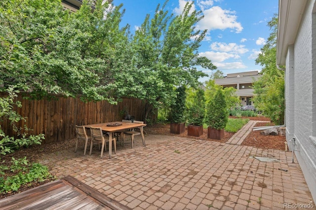 view of patio / terrace featuring fence and outdoor dining space