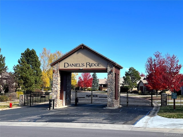 view of property's community featuring fence and a gate