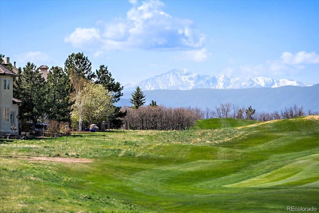 view of home's community featuring a mountain view and golf course view