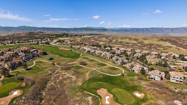 aerial view with view of golf course, a residential view, and a mountain view