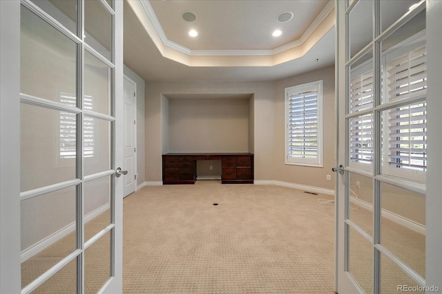 walk in closet with a tray ceiling, visible vents, french doors, and carpet