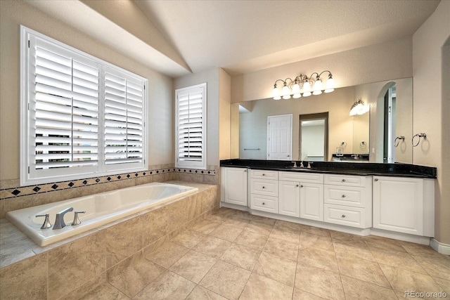 full bathroom featuring vanity, lofted ceiling, and a bath