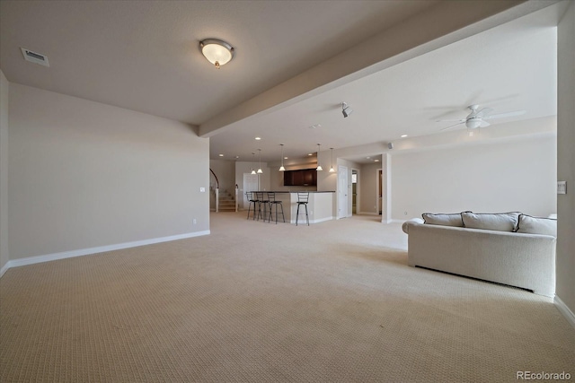 living room with ceiling fan, light colored carpet, visible vents, baseboards, and recessed lighting