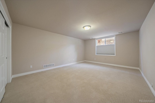 unfurnished bedroom featuring visible vents, a closet, and light colored carpet
