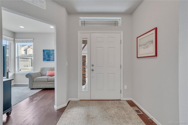 entryway featuring dark wood finished floors, visible vents, and baseboards