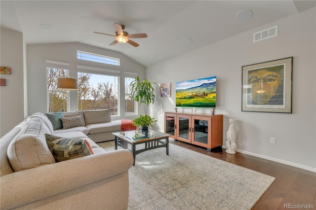 living room with baseboards, visible vents, a ceiling fan, lofted ceiling, and dark wood-style flooring