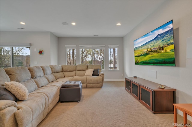 living area featuring light carpet, visible vents, a wealth of natural light, and recessed lighting