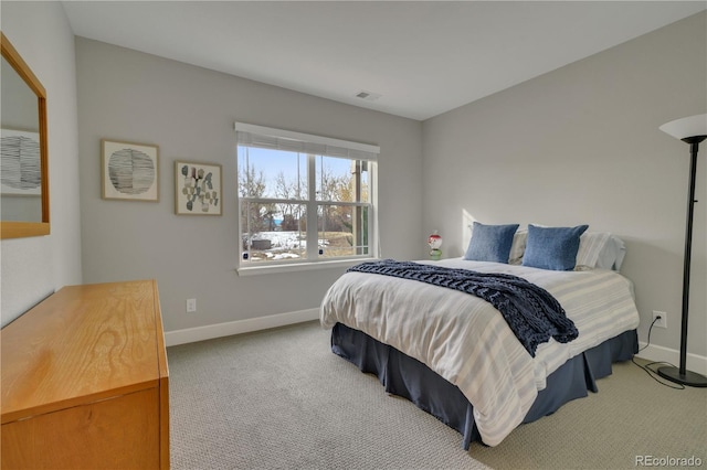 bedroom with carpet floors, baseboards, and visible vents