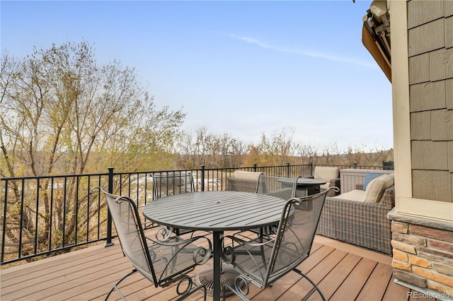 wooden terrace with outdoor dining space