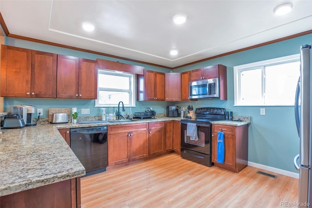 kitchen featuring sink, ornamental molding, light stone counters, black appliances, and light hardwood / wood-style flooring