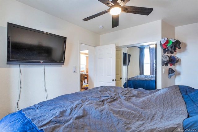 bedroom with ceiling fan and a closet