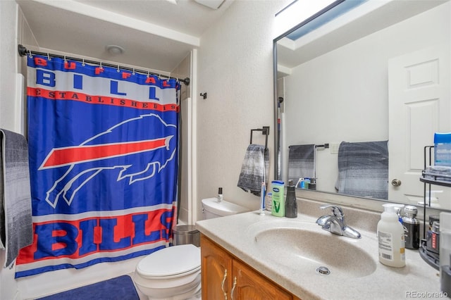 bathroom with vanity, a shower with shower curtain, and toilet