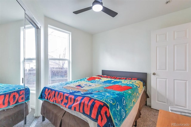 carpeted bedroom featuring ceiling fan