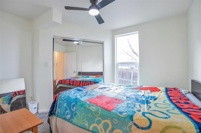 carpeted bedroom featuring a closet and ceiling fan