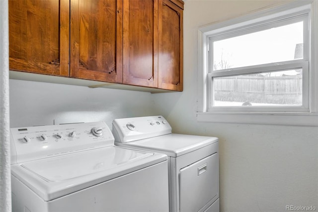 washroom with cabinets and washer and clothes dryer