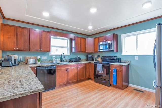 14050 W 8th Ave, Golden, CO 80401 - kitchen with black appliances, light wood-style flooring, ornamental molding, light stone countertops, and brown cabinetry