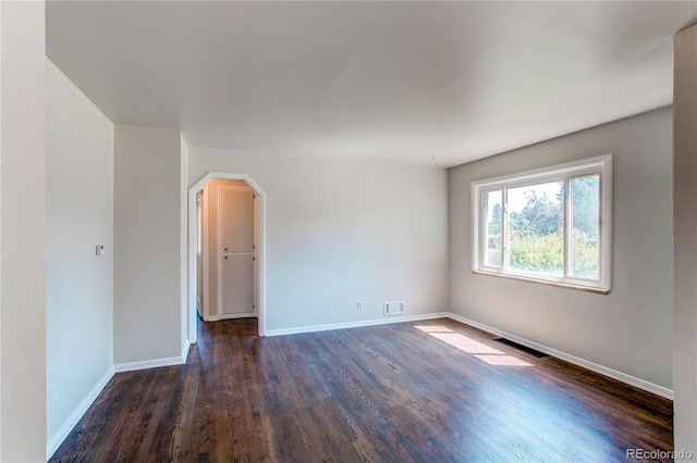 3311 S Eudora St, Denver, CO 80222 - unfurnished room with dark wood-type flooring and arched walkways