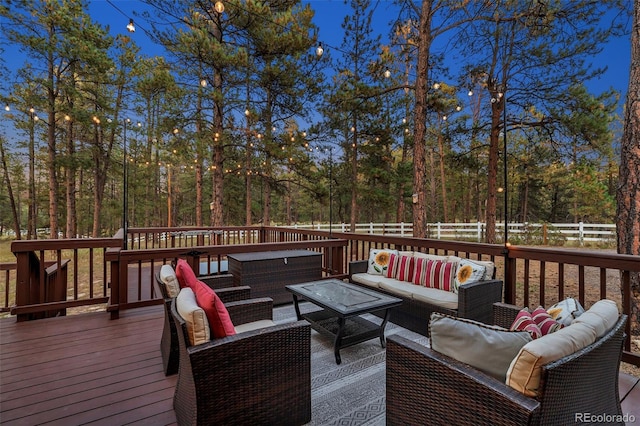 wooden terrace with an outdoor hangout area