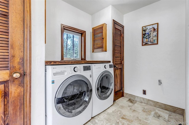 clothes washing area featuring washing machine and clothes dryer