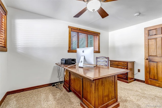 carpeted home office featuring ceiling fan