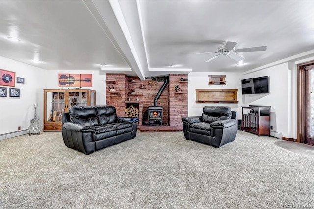 carpeted living room with a baseboard radiator, ceiling fan, and a wood stove