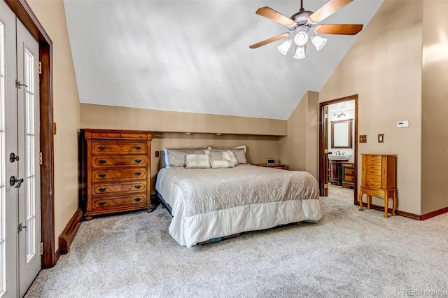 bedroom with ceiling fan, light colored carpet, lofted ceiling, and ensuite bathroom