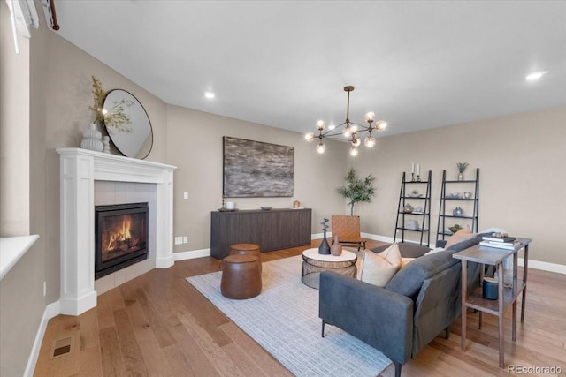 1721 Wingfeather Ln, Castle Rock, CO 80108 - living area featuring wood finished floors, a fireplace, a chandelier, and recessed lighting