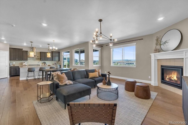 1721 Wingfeather Ln, Castle Rock, CO 80108 - living area featuring a chandelier, plenty of natural light, light wood-style floors, and recessed lighting