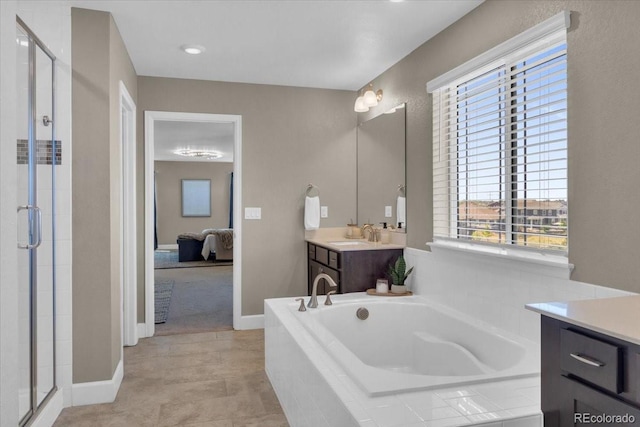 1721 Wingfeather Ln, Castle Rock, CO 80108 - ensuite bathroom featuring vanity, a bath, a stall shower, and tile patterned floors