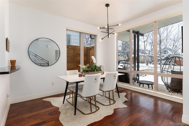 dining room featuring dark hardwood / wood-style flooring and an inviting chandelier