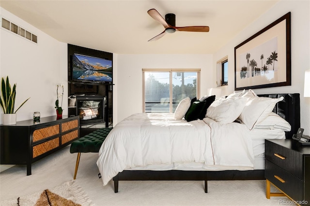 bedroom featuring access to exterior, carpet floors, and ceiling fan