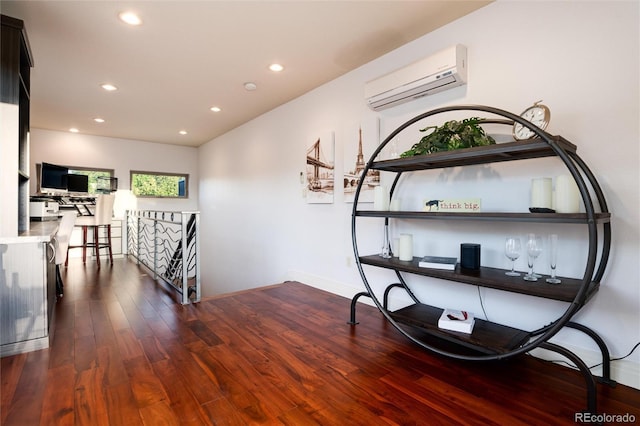 hallway featuring a wall unit AC and dark hardwood / wood-style flooring