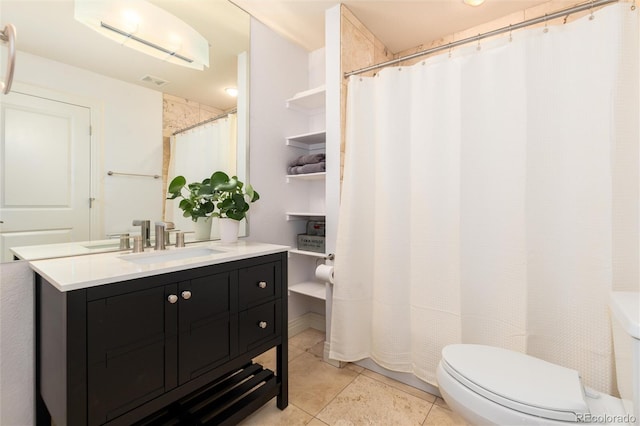 bathroom featuring tile patterned floors, vanity, and toilet