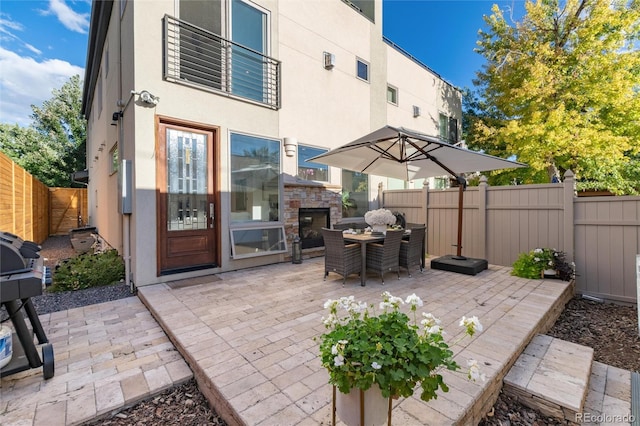 view of patio featuring an outdoor stone fireplace