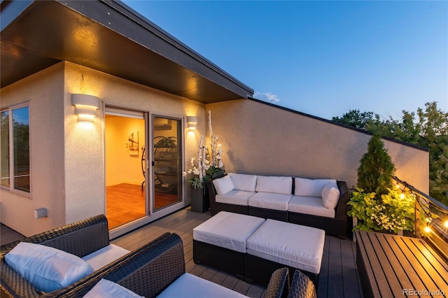 deck at dusk featuring outdoor lounge area