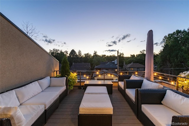 deck at dusk with outdoor lounge area