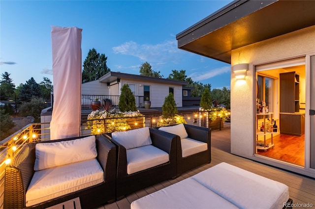 patio terrace at dusk featuring a balcony