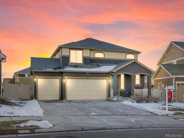 view of front of home with covered porch, concrete driveway, and stucco siding