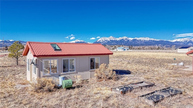 back of house with a mountain view