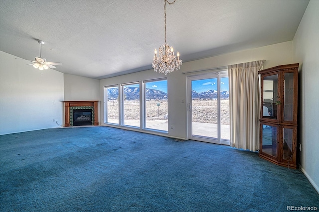 unfurnished living room featuring lofted ceiling, carpet flooring, ceiling fan with notable chandelier, and a textured ceiling